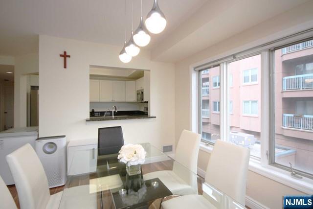 307 Jefferson Court Edgewater, NJ 07020 - Photo 11 of 36 a living room with furniture a window and a flat screen tv