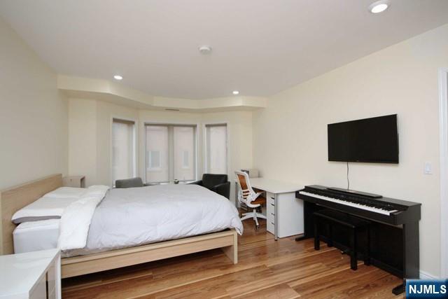 307 Jefferson Court Edgewater, NJ 07020 - Photo 17 of 36 a bedroom with a bed and a flat screen tv