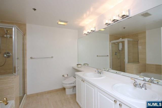 307 Jefferson Court Edgewater, NJ 07020 - Photo 19 of 36 a spacious bathroom with a granite countertop sink a toilet and shower