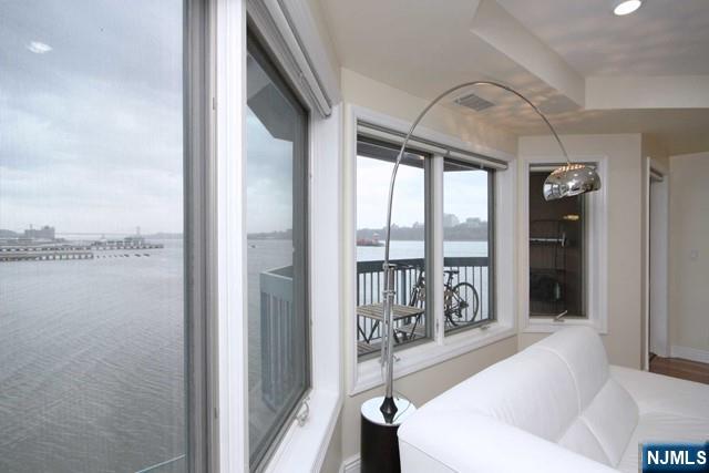 307 Jefferson Court Edgewater, NJ 07020 - Photo 7 of 36 a spacious bedroom with a balcony a bed and a large window