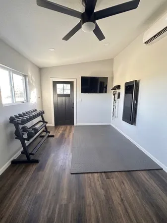 a view of a livingroom with wooden floor and a ceiling fan