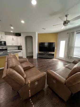 a living room with furniture and a flat screen tv
