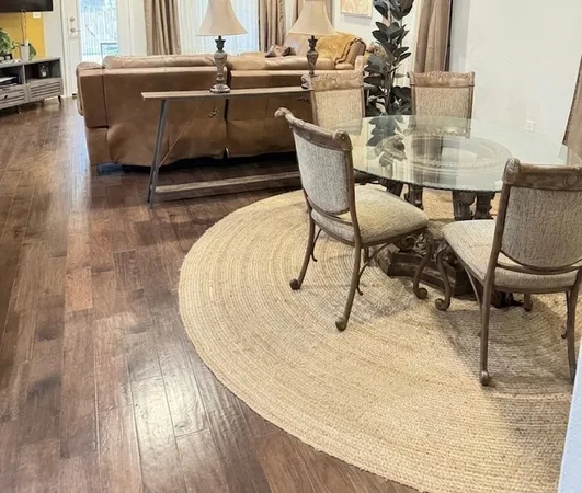 a dining room with furniture and wooden floor