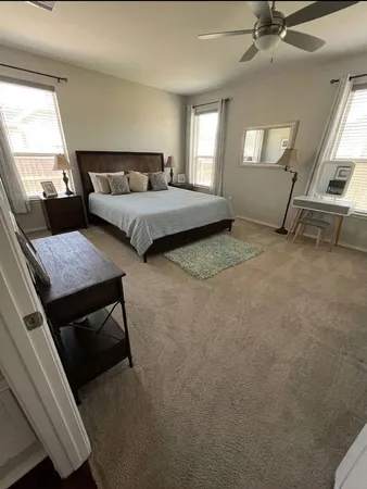 a bedroom with furniture and a window