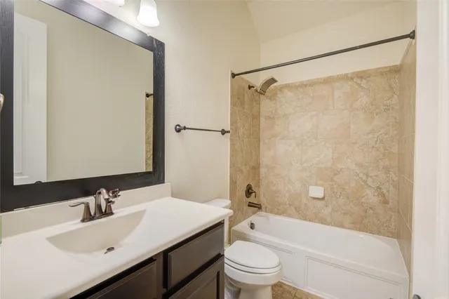 a bathroom with a sink mirror toilet and bathtub