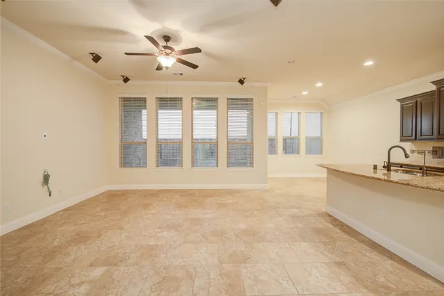 a view of an empty room with window and cabinet