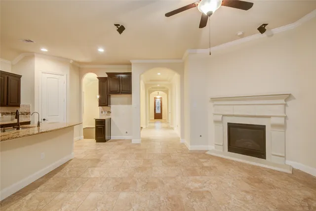 a view of a kitchen with a sink and a fireplace