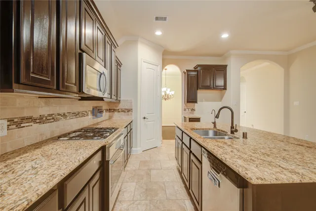 a kitchen with stainless steel appliances granite countertop counter space a sink and cabinets