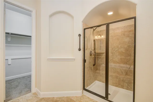 a bathroom with a glass shower door