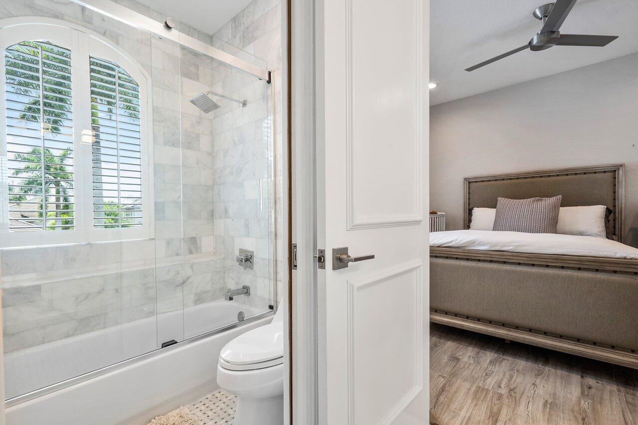 6379 Avalon Pointe Court Boca Raton, FL 33496 - Photo 15 of 37 a bathroom with a toilet and a bathtub