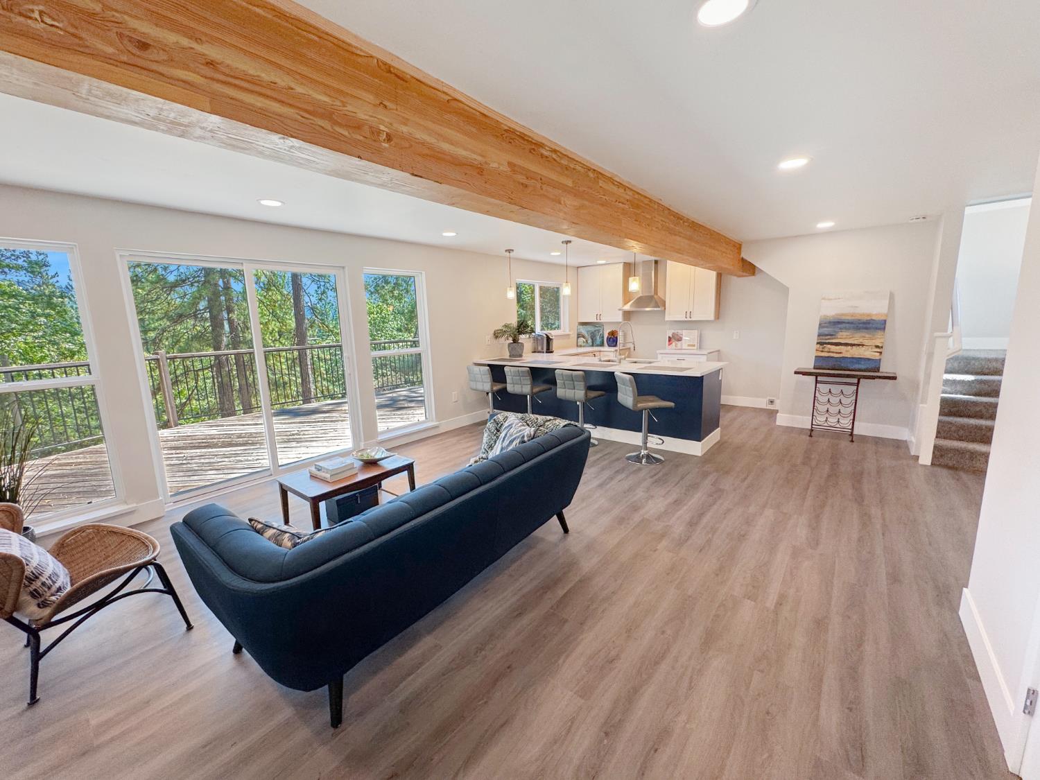 a living room with furniture and large windows