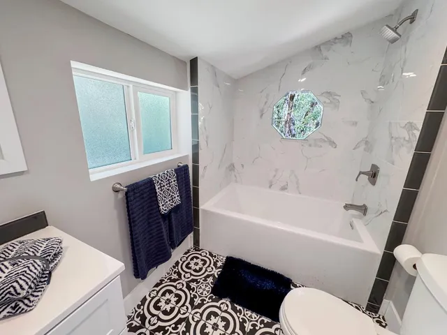 a bathroom with a bathtub and a shower
