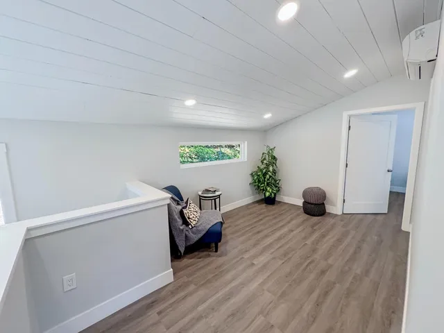 a view of room with furniture and wooden floor
