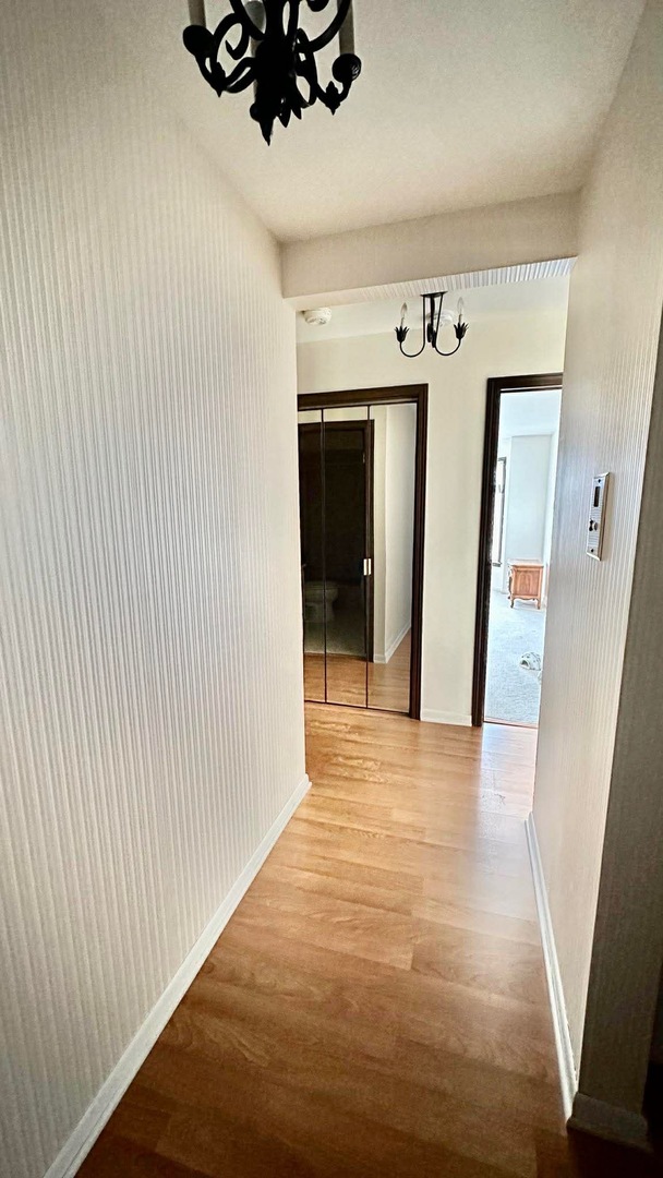 2500 Windsor Mall, Unit 2D Park Ridge, IL 60068 - Photo 12 of 13 a view of a hallway to an empty room with wooden floor