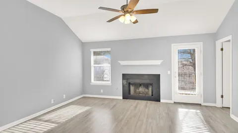 a view of empty room with a fireplace and fan
