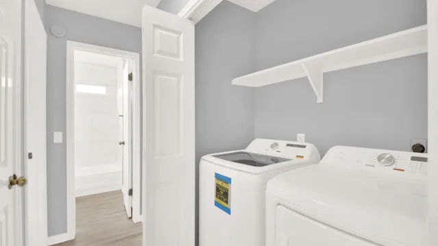 an empty room with wooden floor and ceiling fan