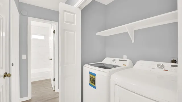 an empty room with wooden floor and ceiling fan