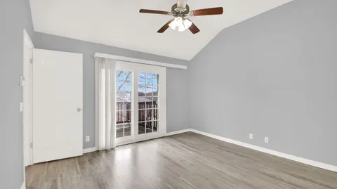 a bathroom with a bathtub shower sink vanity and toilet