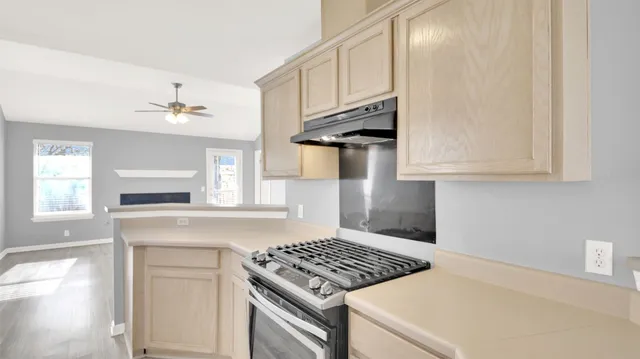 a kitchen with white cabinets and appliances