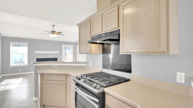 a kitchen with white cabinets and appliances