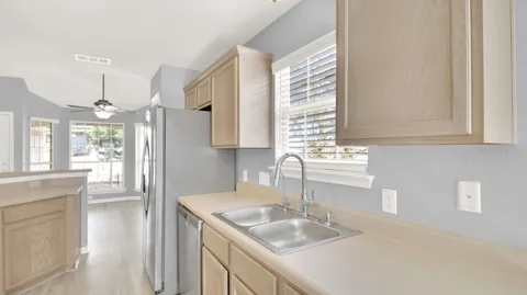 a kitchen with granite countertop a sink and a window