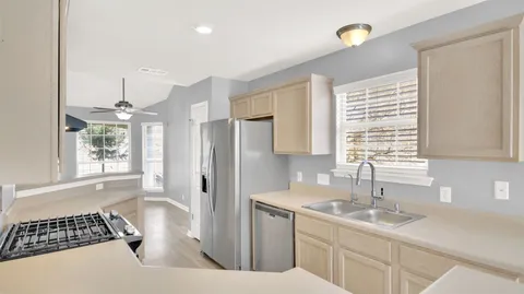 a kitchen with a sink and a refrigerator
