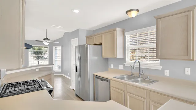 a kitchen with a sink and a refrigerator
