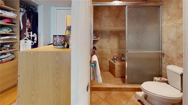 a bathroom with a toilet and a shower