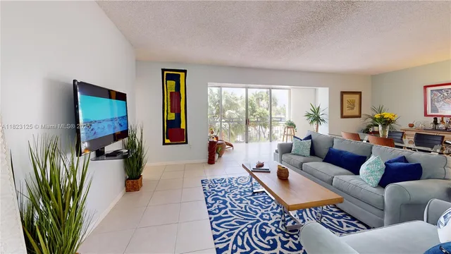 a living room with furniture a couch and a bookshelf