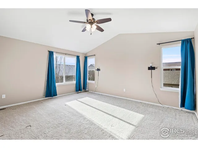 a view of a livingroom with a ceiling fan and window