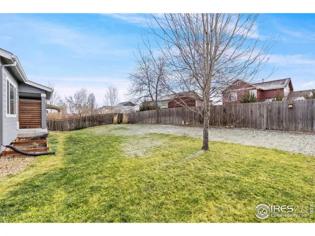 a swimming pool with outdoor seating and yard