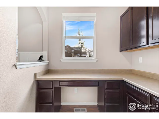 a kitchen with a sink and a mirror