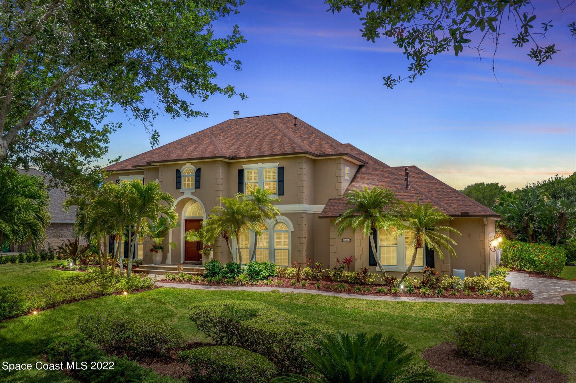 581 Nightingale Drive Indialantic, FL 32903 - Photo 1 of 67 a front view of a house with garden