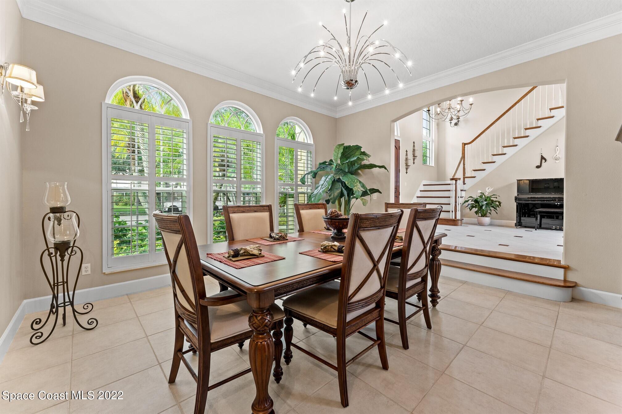 581 Nightingale Drive Indialantic, FL 32903 - Photo 14 of 67 a view of a dining room with furniture a chandelier and a rug