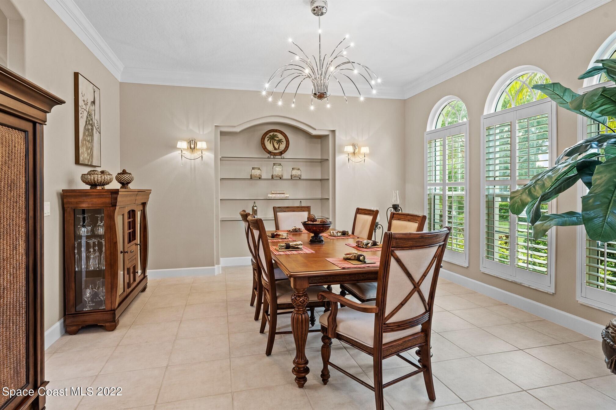 581 Nightingale Drive Indialantic, FL 32903 - Photo 15 of 67 a view of a dining room with furniture and a chandelier