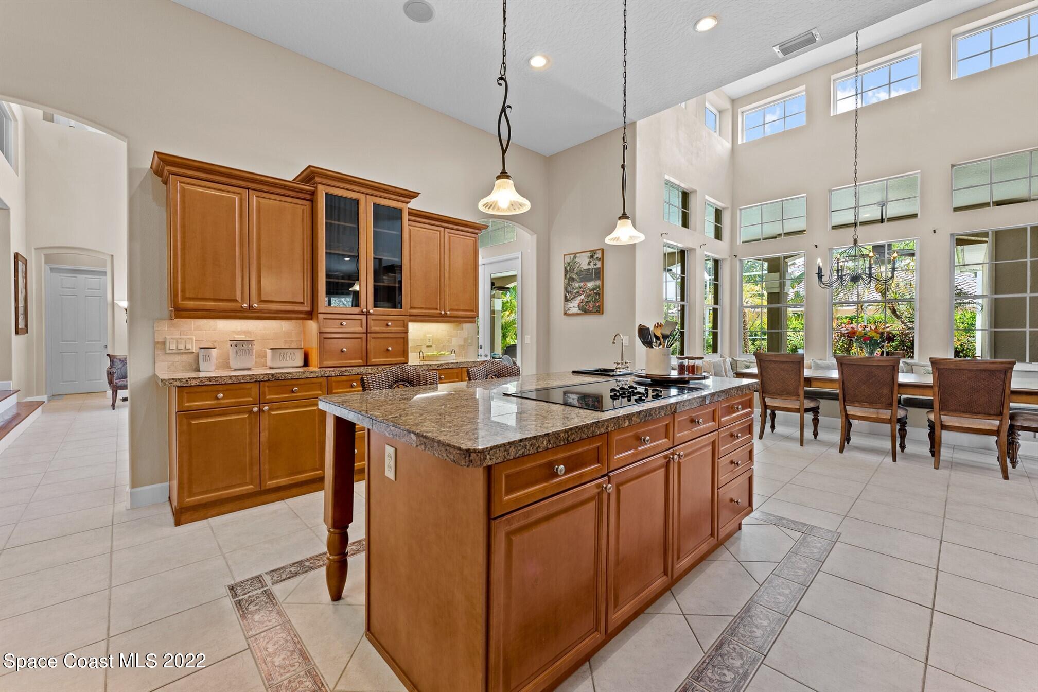 581 Nightingale Drive Indialantic, FL 32903 - Photo 19 of 67 a kitchen with stainless steel appliances granite countertop a stove and cabinets