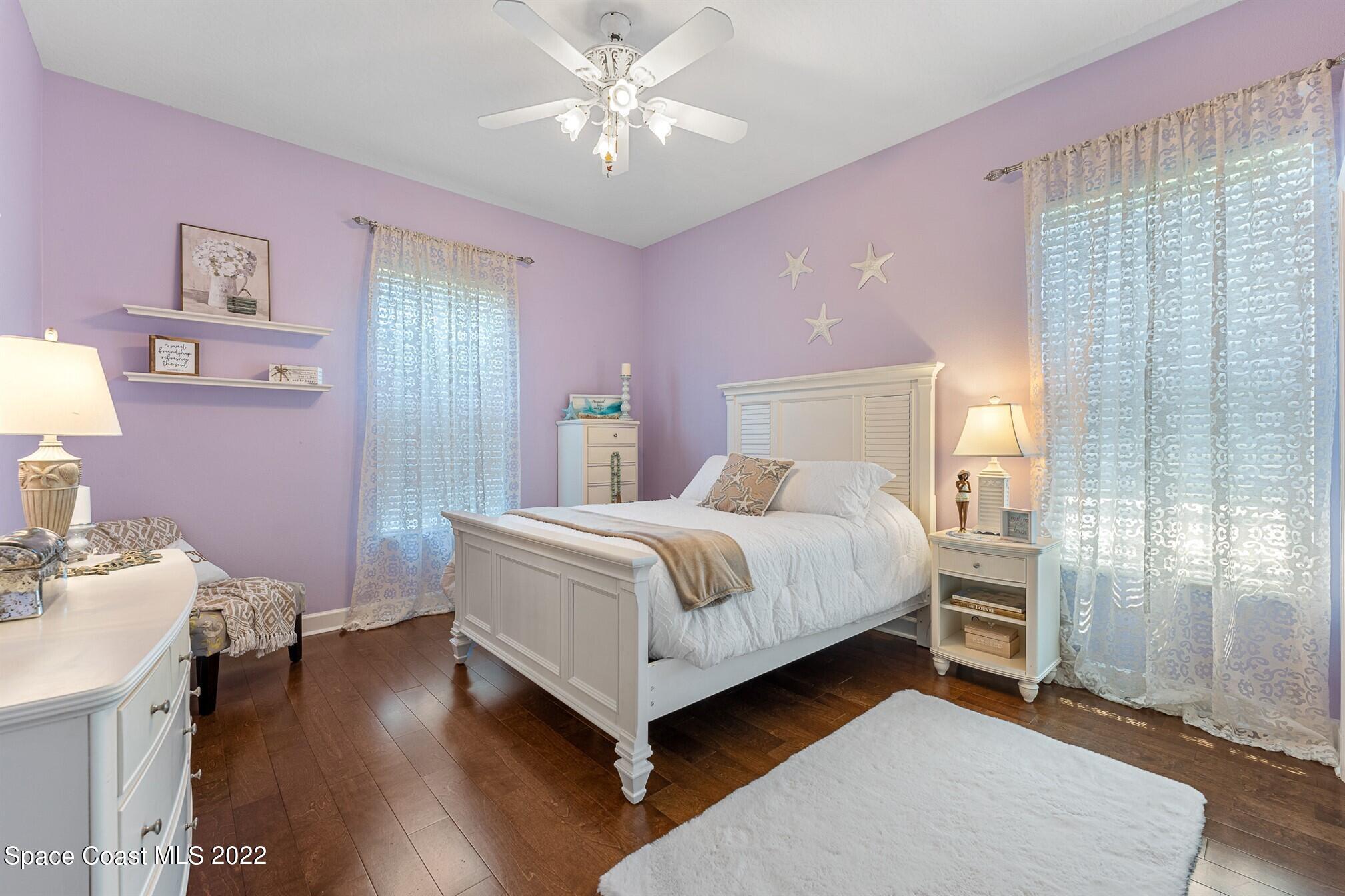 581 Nightingale Drive Indialantic, FL 32903 - Photo 29 of 67 a bedroom with a bed and a chandelier