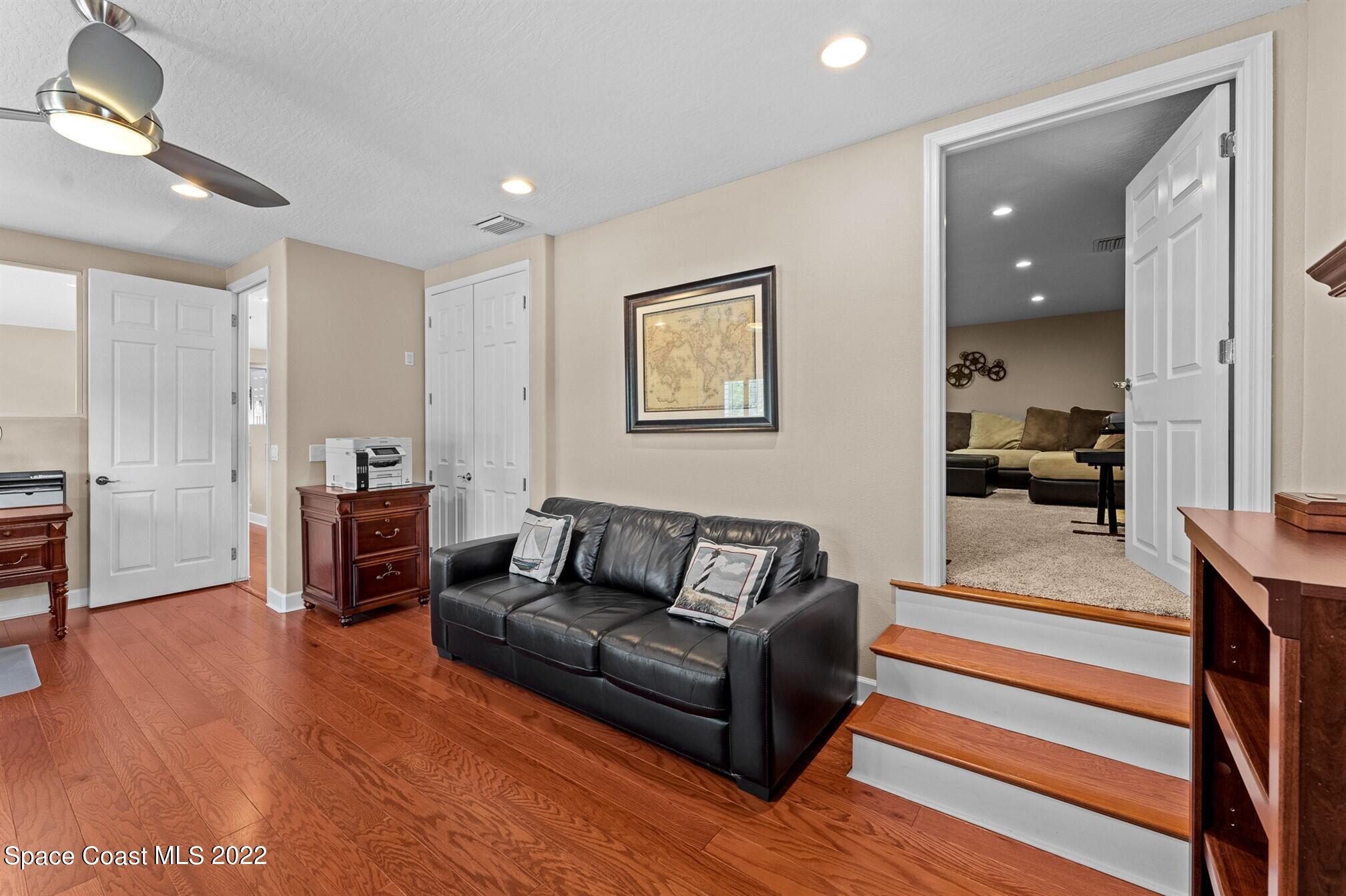 581 Nightingale Drive Indialantic, FL 32903 - Photo 35 of 67 a living room with furniture and a wooden floor