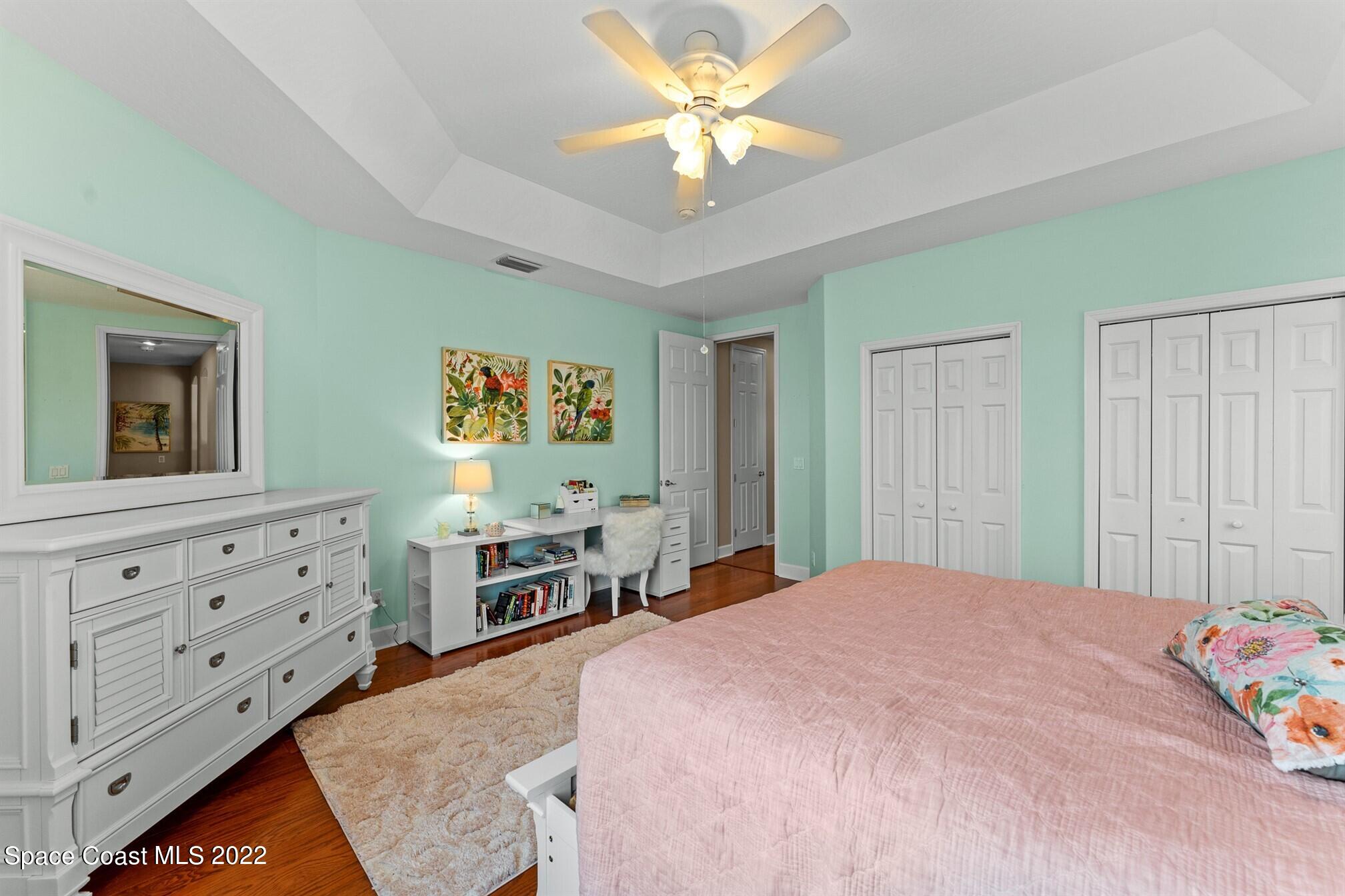 581 Nightingale Drive Indialantic, FL 32903 - Photo 40 of 67 a bedroom with a bed and a dresser in it