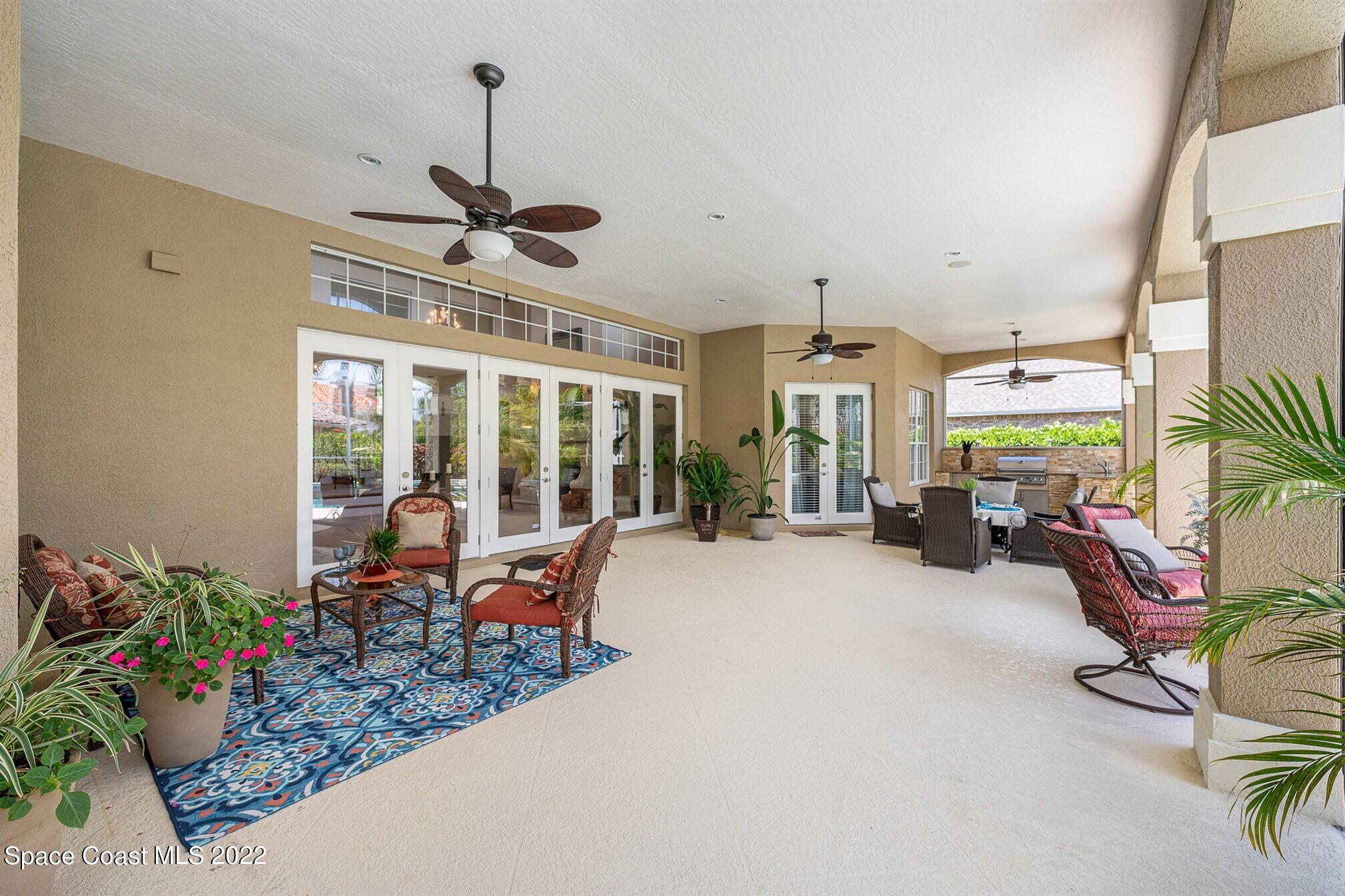 581 Nightingale Drive Indialantic, FL 32903 - Photo 41 of 67 a very nice looking room with a large window and potted plants