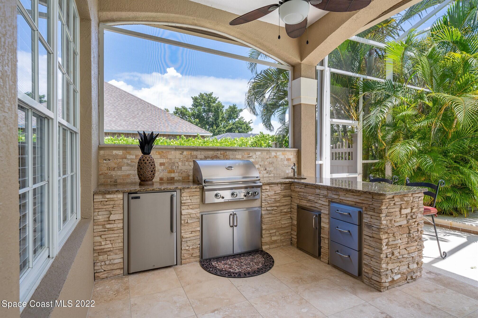 581 Nightingale Drive Indialantic, FL 32903 - Photo 45 of 67 a open kitchen with stainless steel appliances granite countertop a stove a refrigerator and a microwave oven