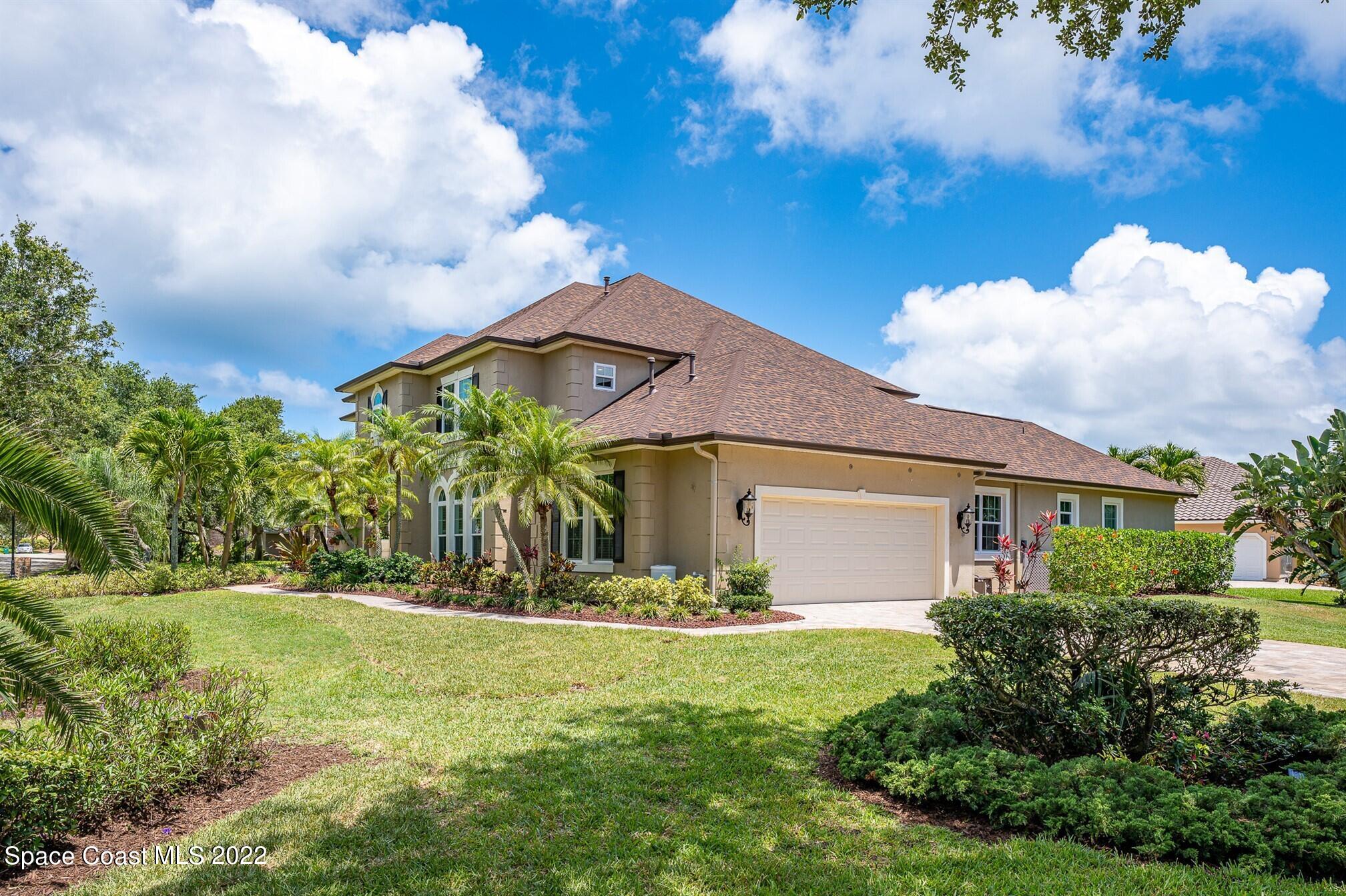 581 Nightingale Drive Indialantic, FL 32903 - Photo 5 of 67 a front view of a house with garden