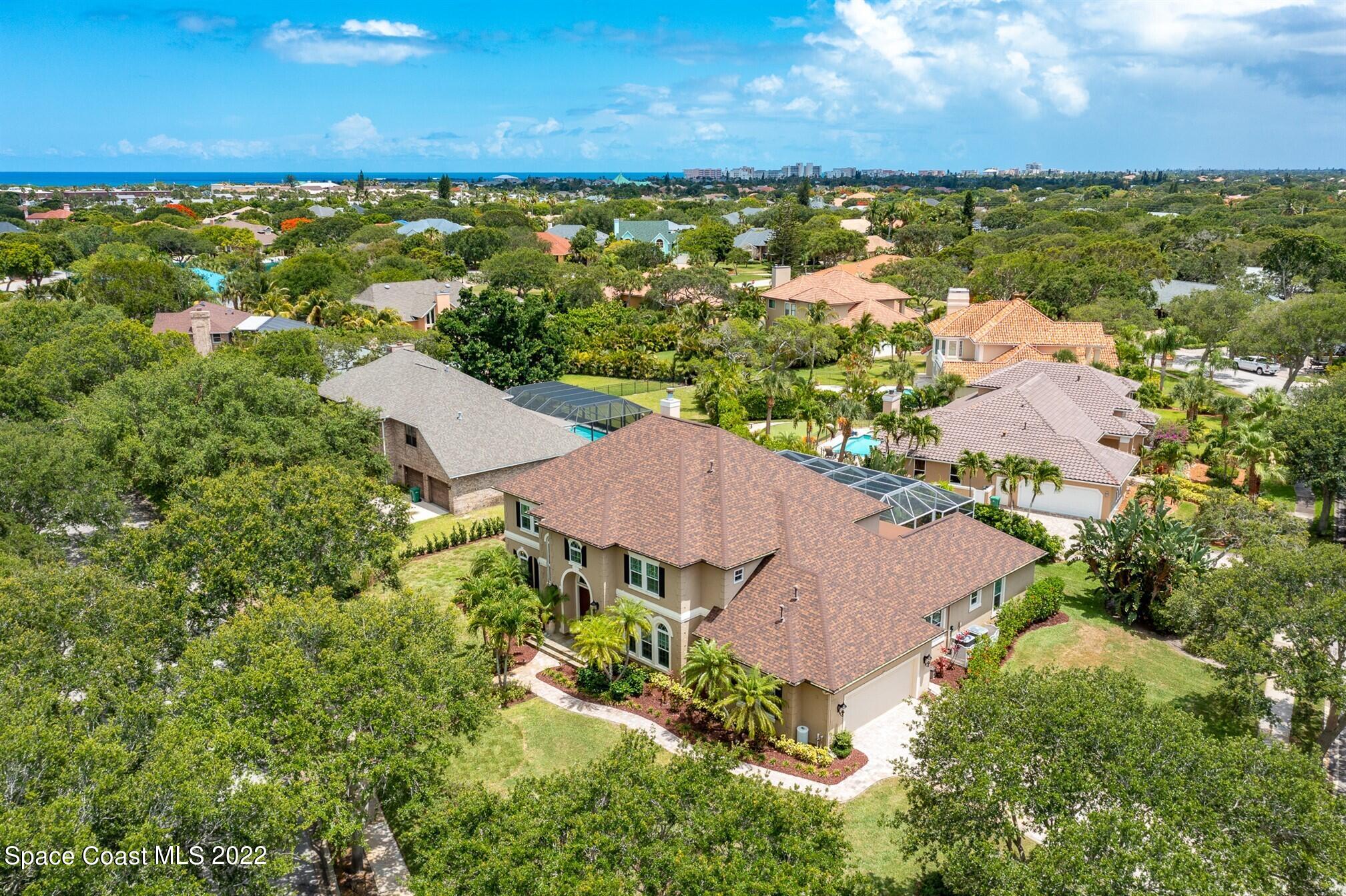 581 Nightingale Drive Indialantic, FL 32903 - Photo 61 of 67 an aerial view of residential houses with outdoor space and trees