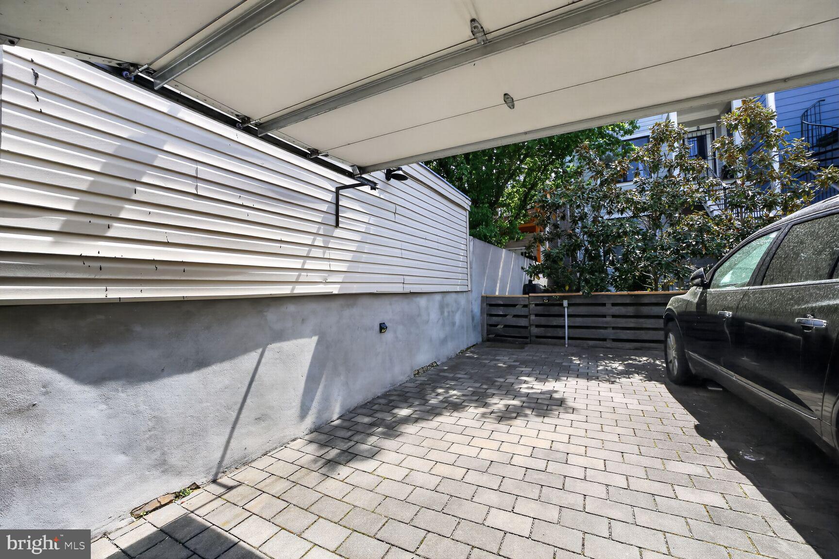 1232 I Street Northeast, Unit 1 Washington, DC 20002 - Photo 54 of 59 Spacious driveway with lush greenery.