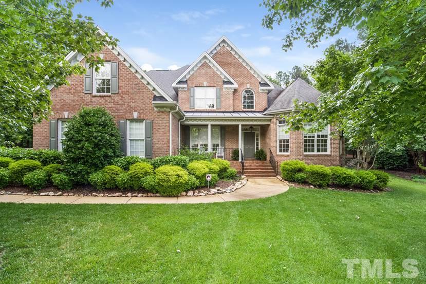 7212 Small Ridge Circle Raleigh, NC 27614 - Photo 1 of 24 a front view of a house with a garden and plants