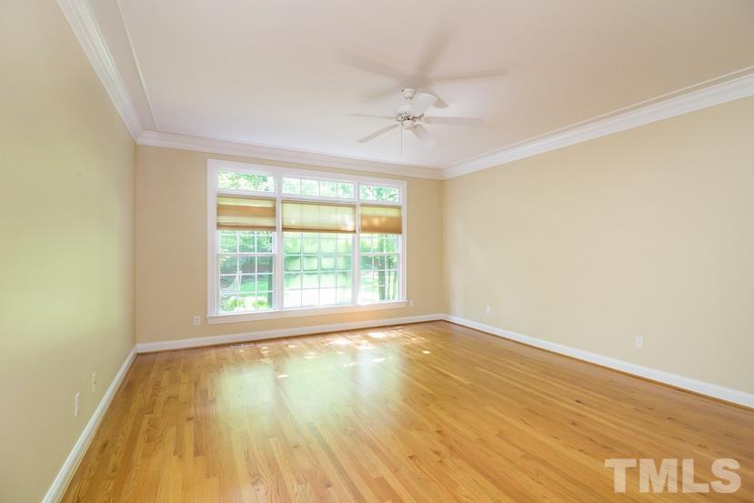 7212 Small Ridge Circle Raleigh, NC 27614 - Photo 14 of 24 a view of an empty room with wooden floor and a window