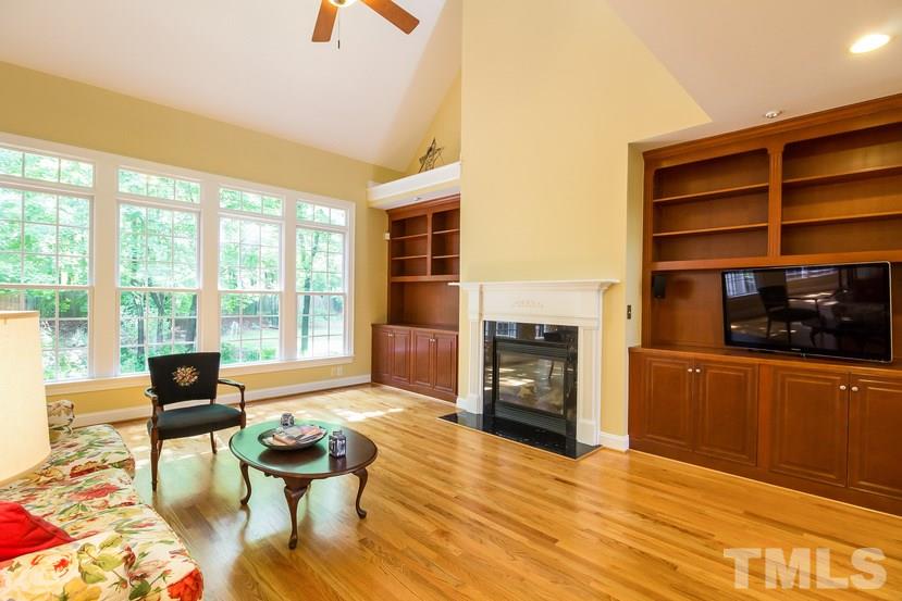 7212 Small Ridge Circle Raleigh, NC 27614 - Photo 8 of 24 a living room with furniture a fireplace and a flat screen tv