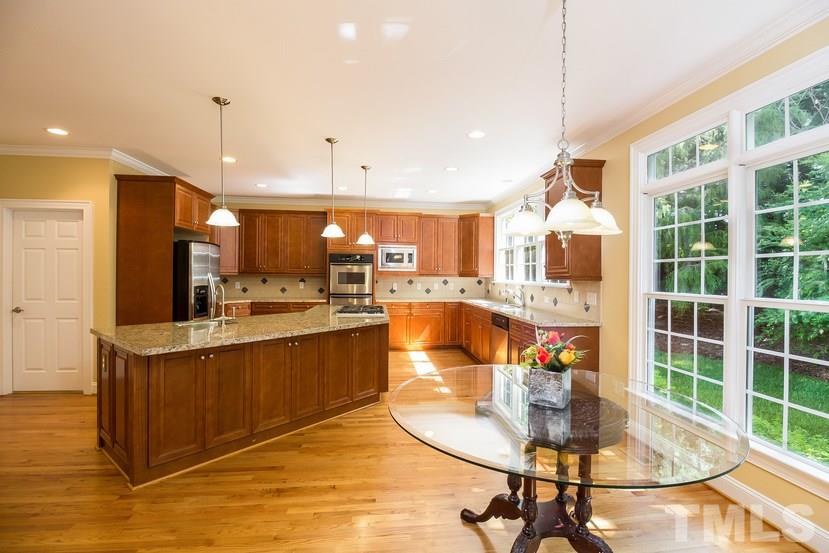 7212 Small Ridge Circle Raleigh, NC 27614 - Photo 10 of 24 a kitchen with stainless steel appliances granite countertop a sink and a table