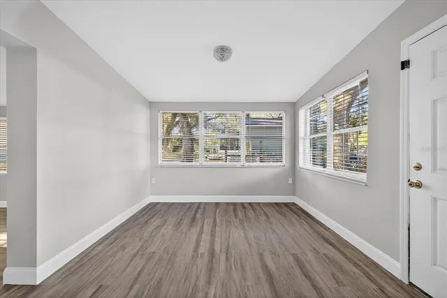 a view of empty room with wooden floor