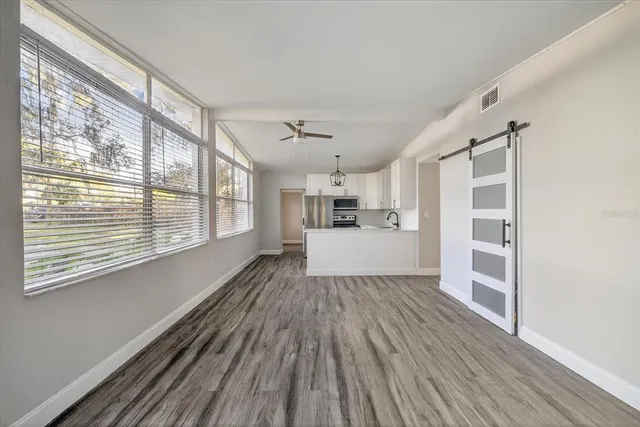 a large kitchen with stainless steel appliances a refrigerator and a sink